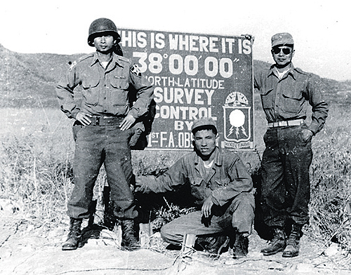 soldiers in front of sign